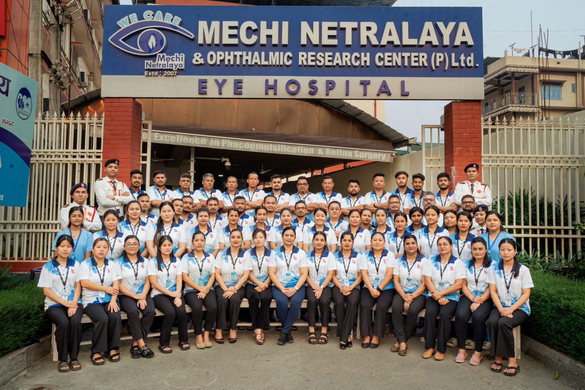 Group photo of Mechi Netralaya hospital staff in front of the hospital entrance