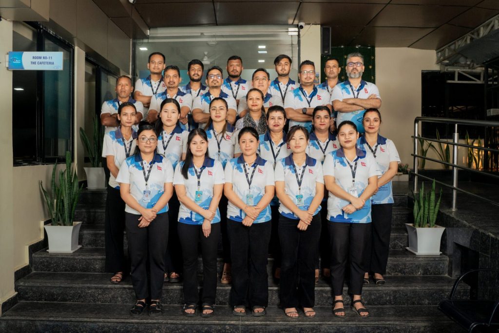 Group of people in uniform standing on stairs in an office building