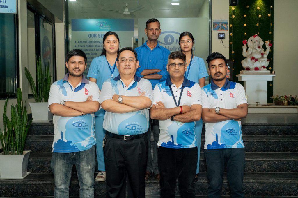 Mechi Netralaya staff team standing on steps outside eye clinic