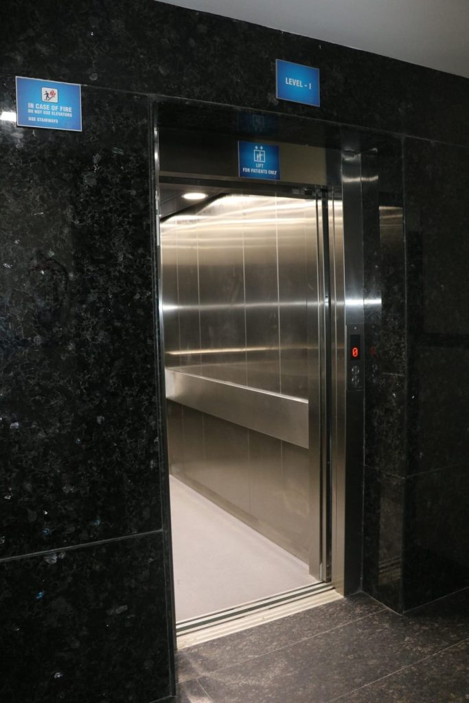 Elevator door with signs indicating level 1 and patients only