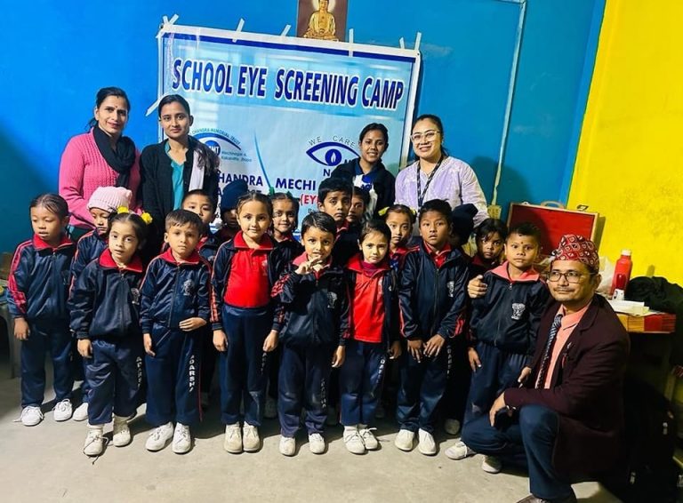 Group of children and adults at a school eye screening camp