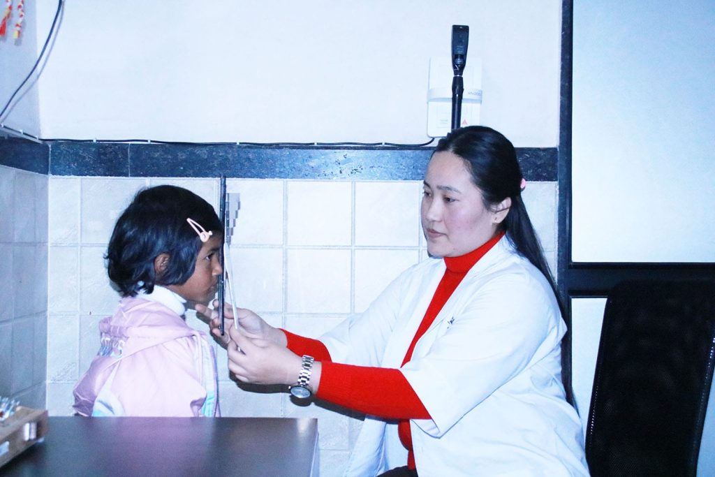 doctor examining a young girl in a medical setting