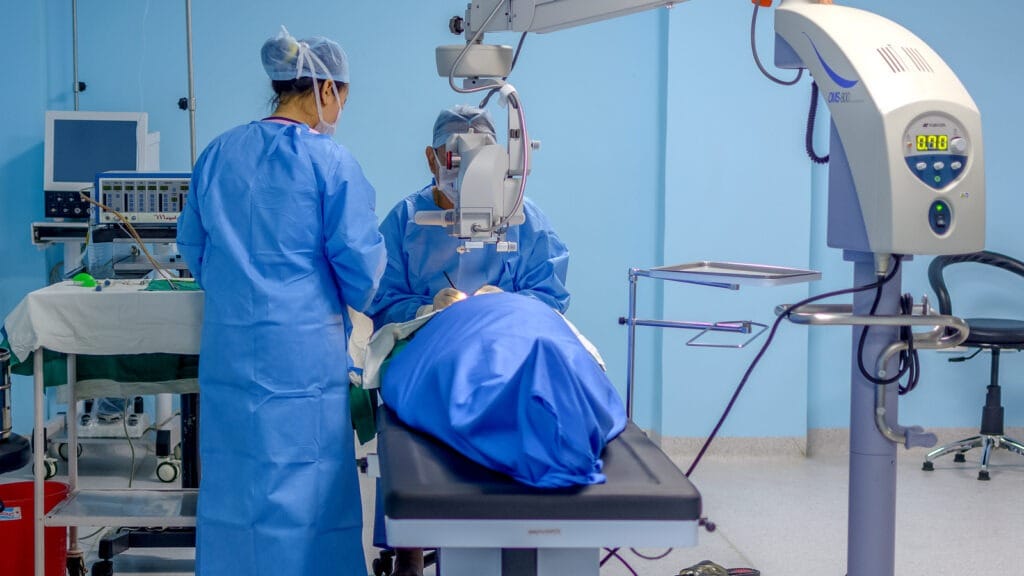 Medical professionals performing eye surgery in a clinical setting