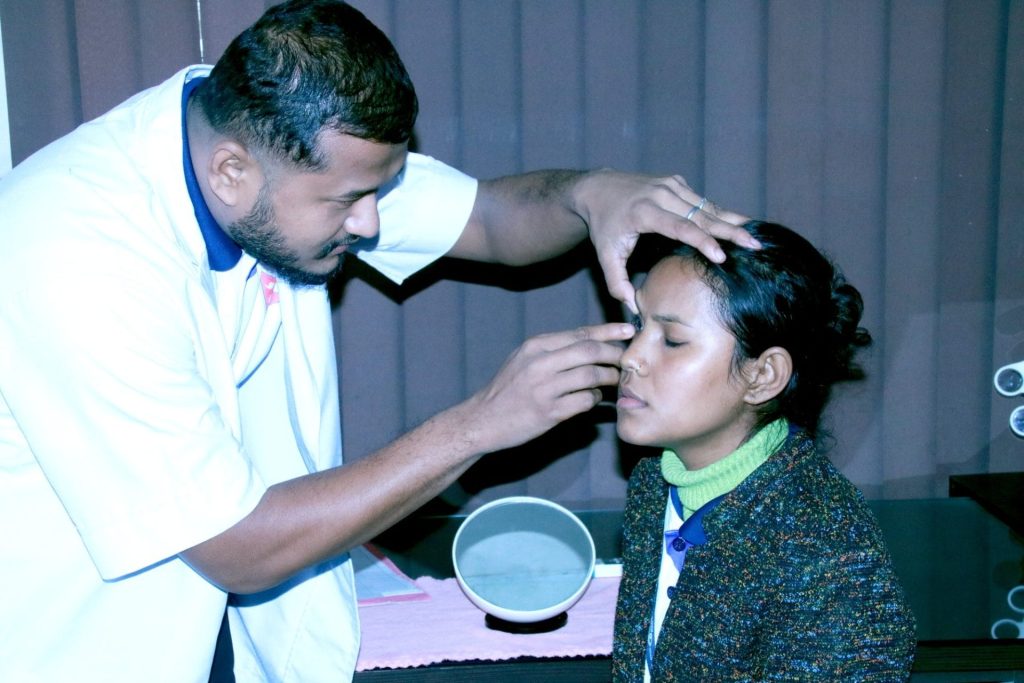 doctor examining a young girl's eyes