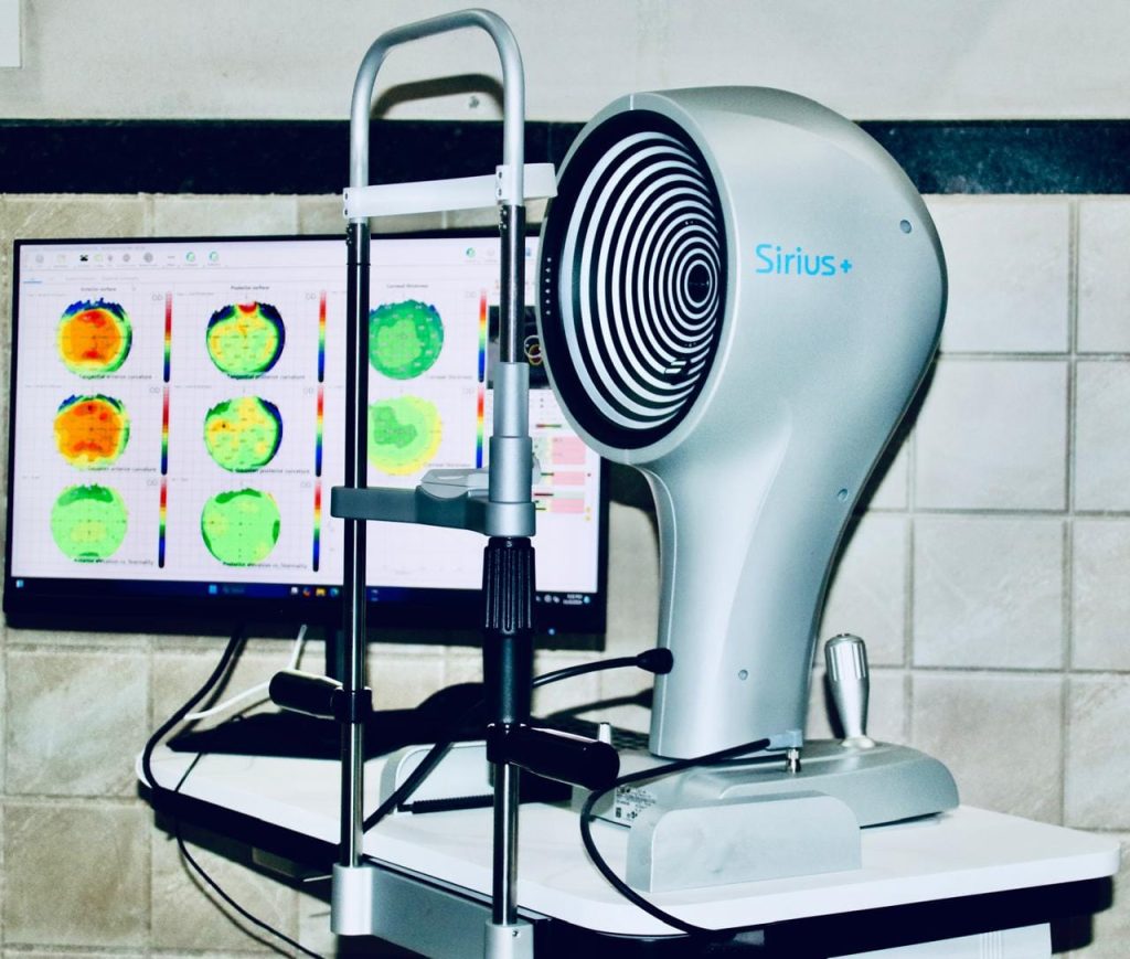 Sirius+ machine with computer monitor displaying corneal topography scans