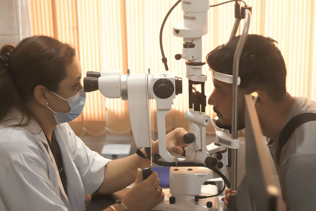 Eye doctor examining patient's vision with phoropter machine