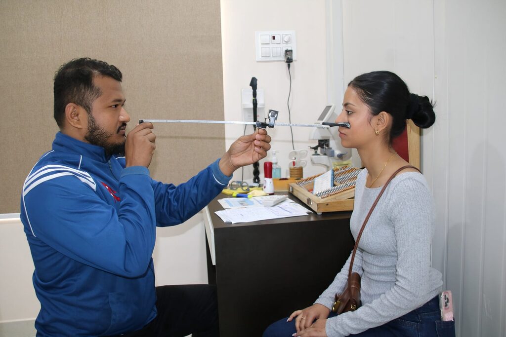 Man using a device to measure a woman's eyes in an optometrist's office