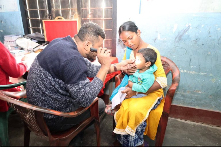 doctor examining a baby's eyes with an ophthalmoscope
